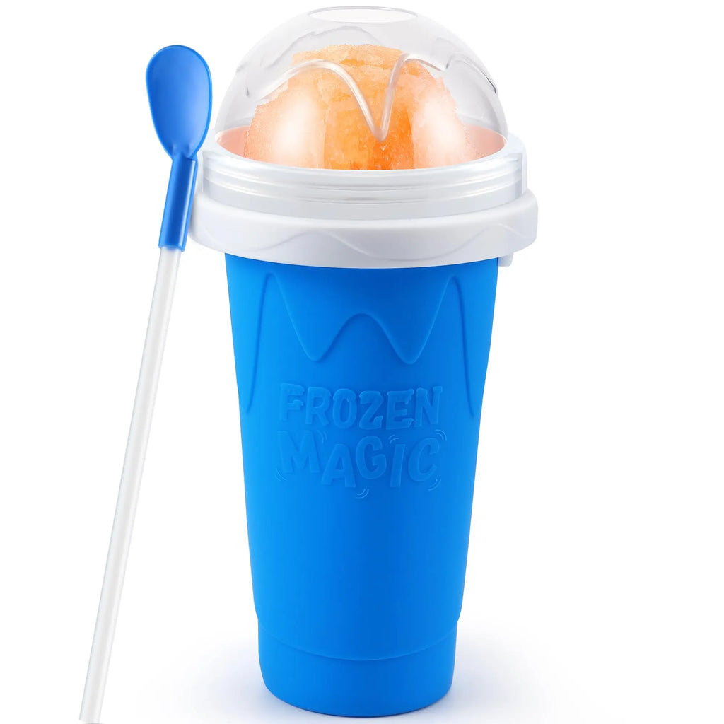 Blue squeeze slushy maker cup with a white lid, clear dome, orange slushy inside, and a blue spoon-straw.