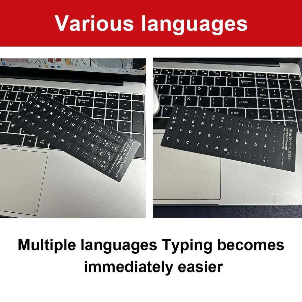 Silver 15.6-inch laptop with black keyboard stickers showing Spanish and German language layouts.