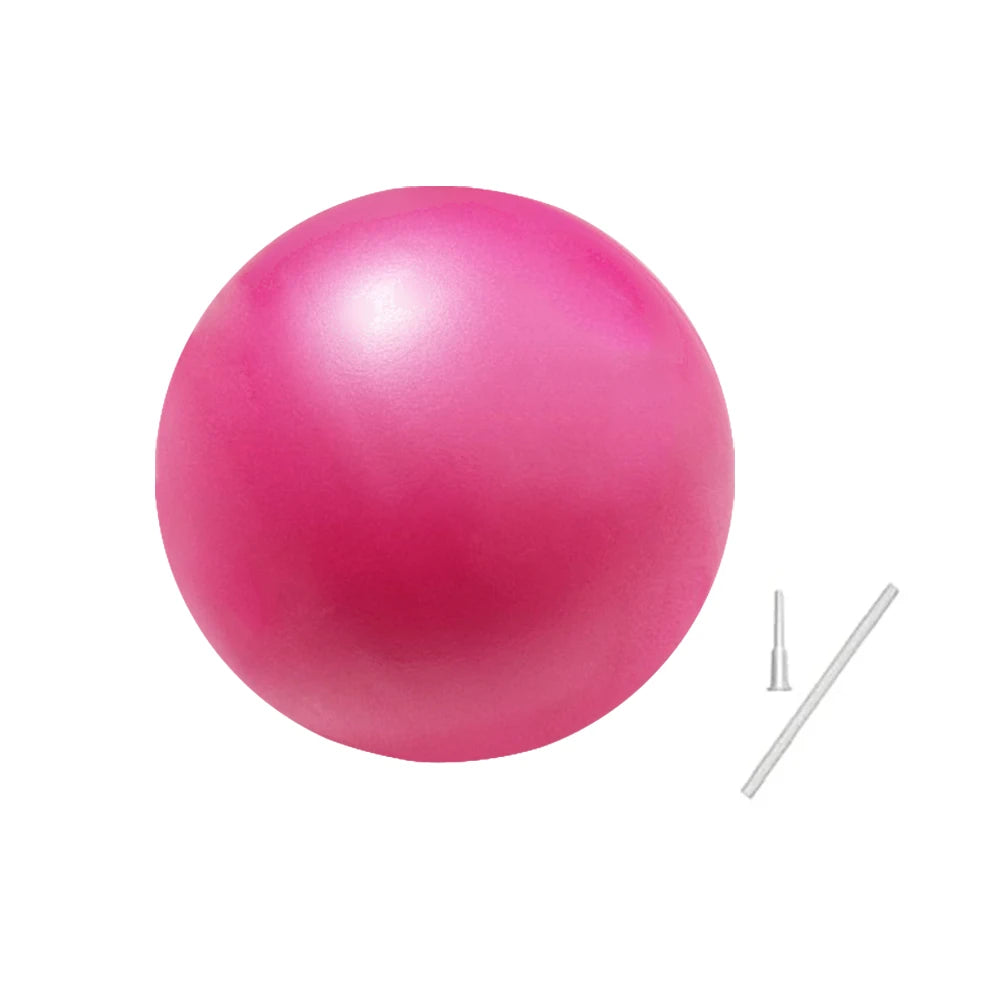 A bright pink inflatable pilates or yoga ball with a small inflation straw and stopper.