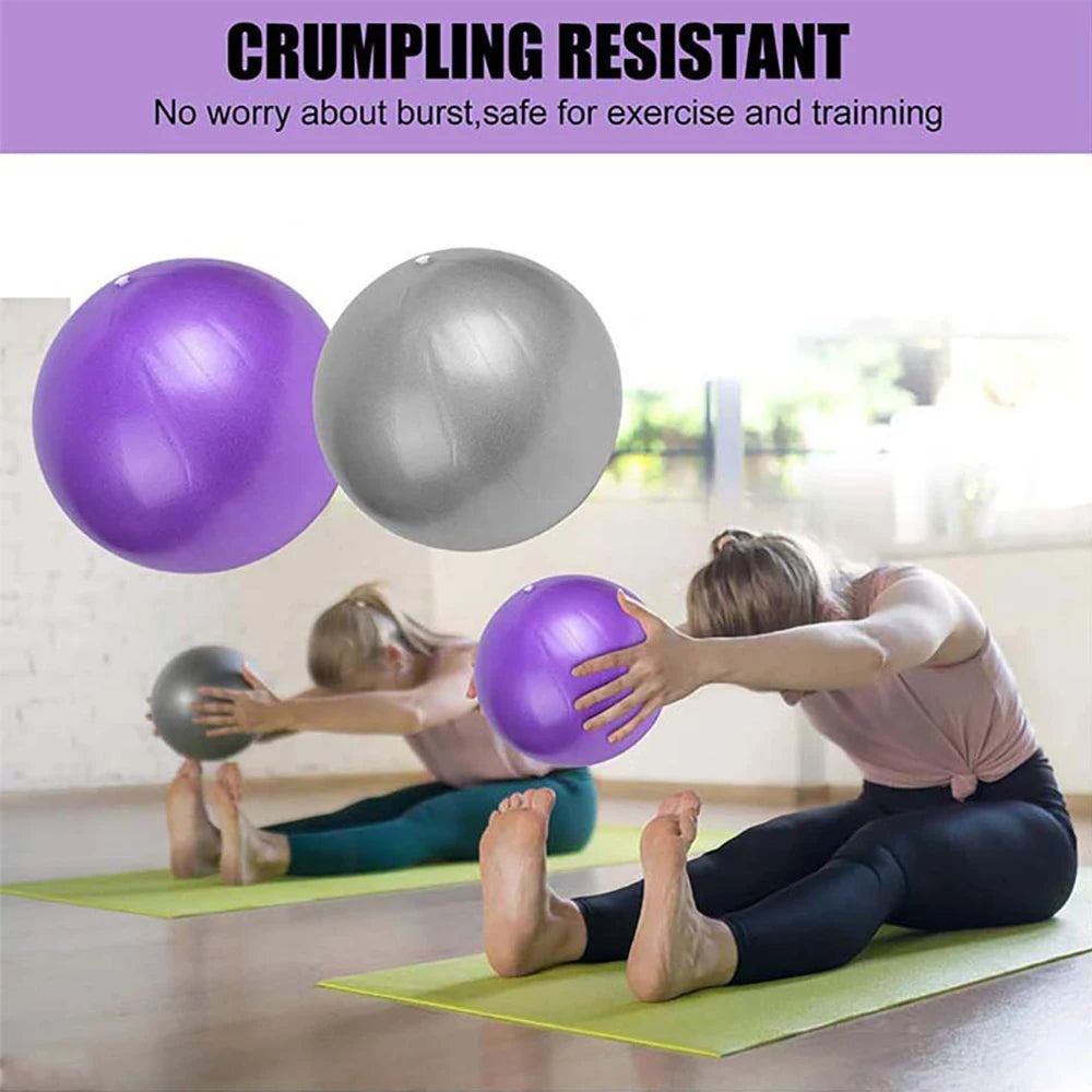 Two purple and silver anti-burst yoga balls with women using them for floor exercise on gym mats.