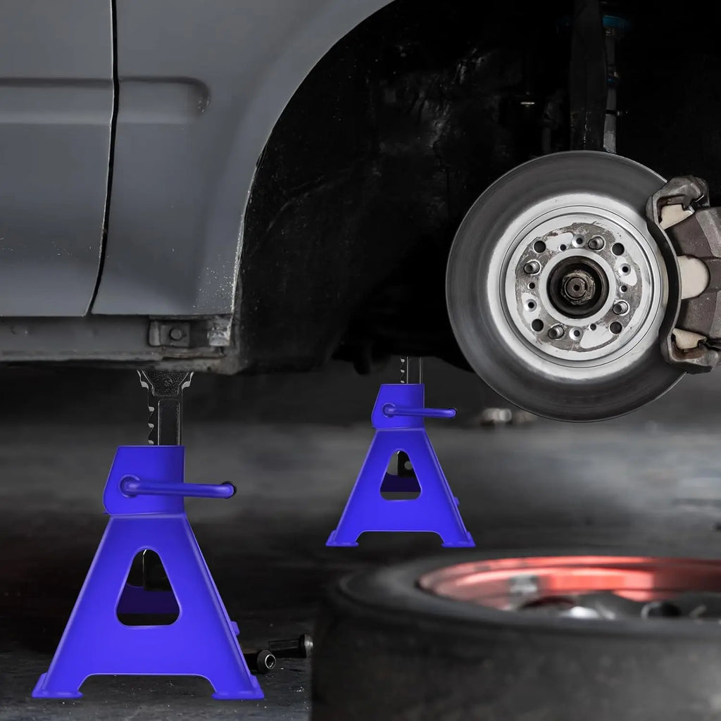 Two blue heavy-duty A-frame ratchet jack stands supporting a raised car with a removed wheel.