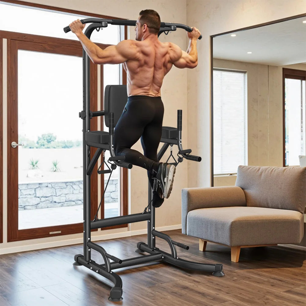 Black multi-function power tower with a pull-up bar, padded backrest, and dip handles, in use.
