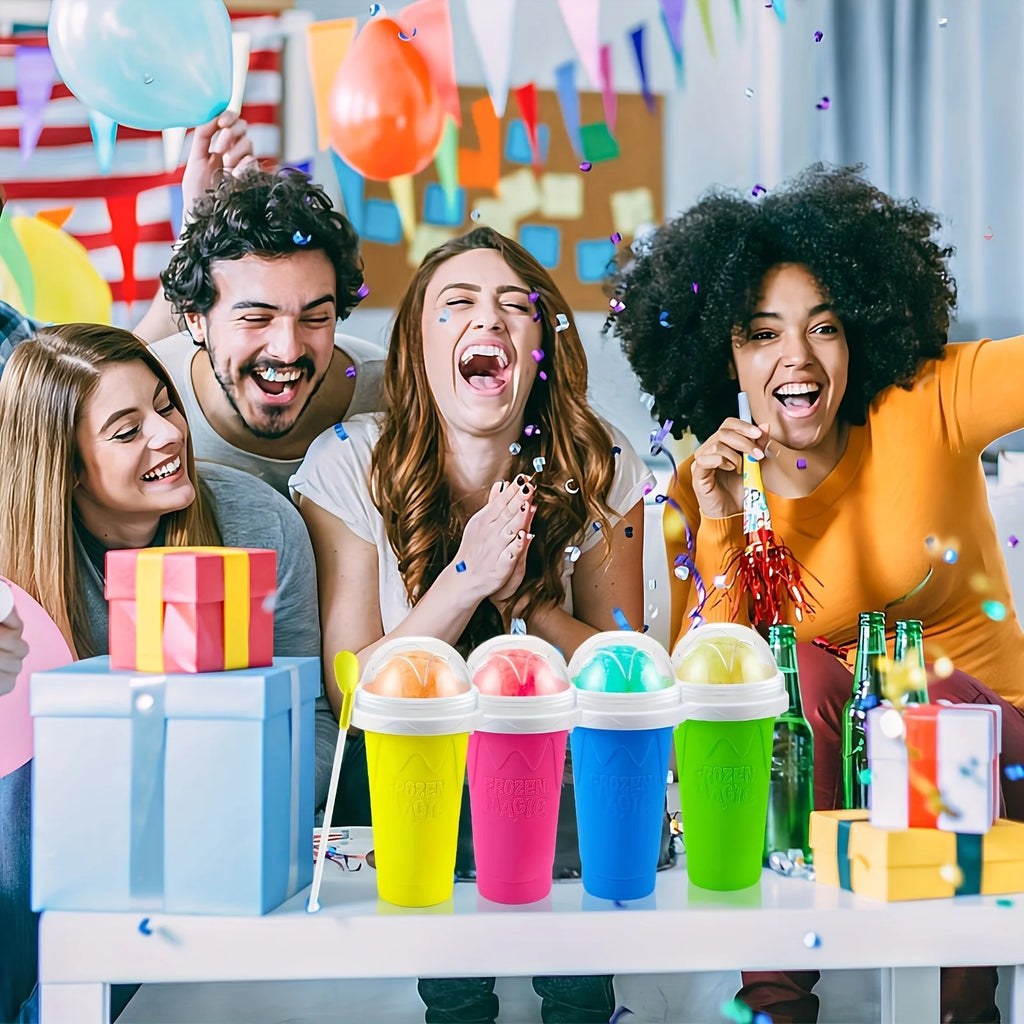 Four vibrant slushy squeeze cups in yellow, pink, blue, and green, each with a clear lid and spoon, at a party.