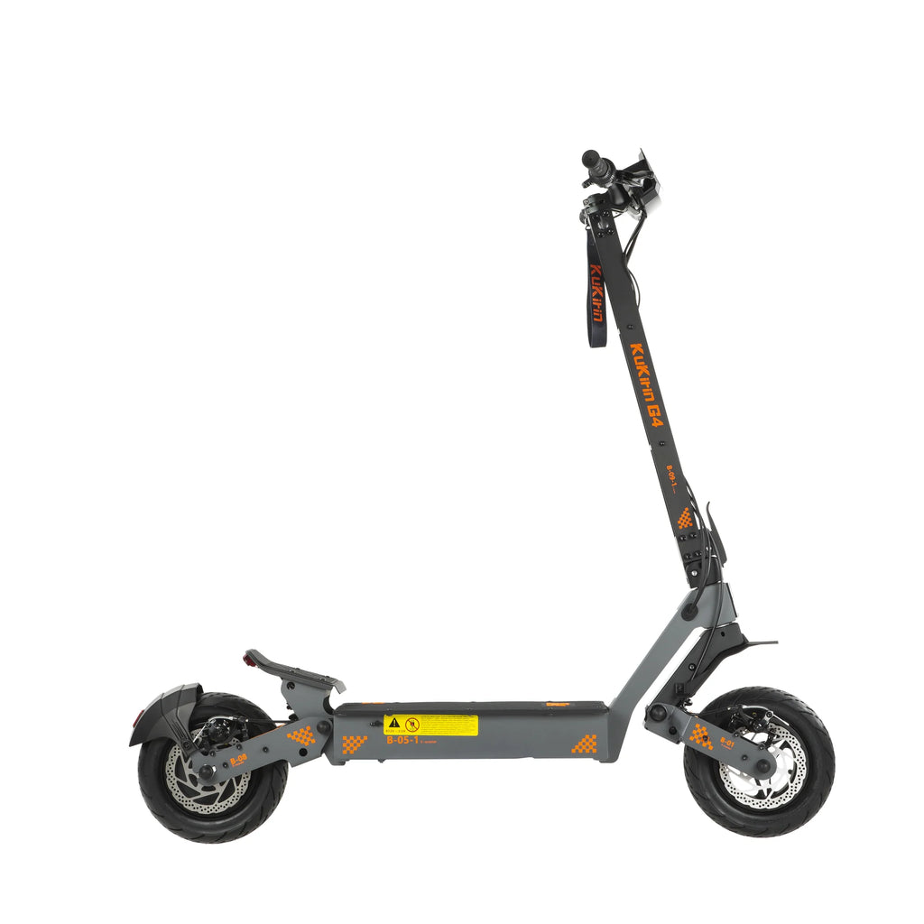 Gray Kukirin G4 folding electric scooter with 11-inch fat tires, orange accents, and dual disc brakes.