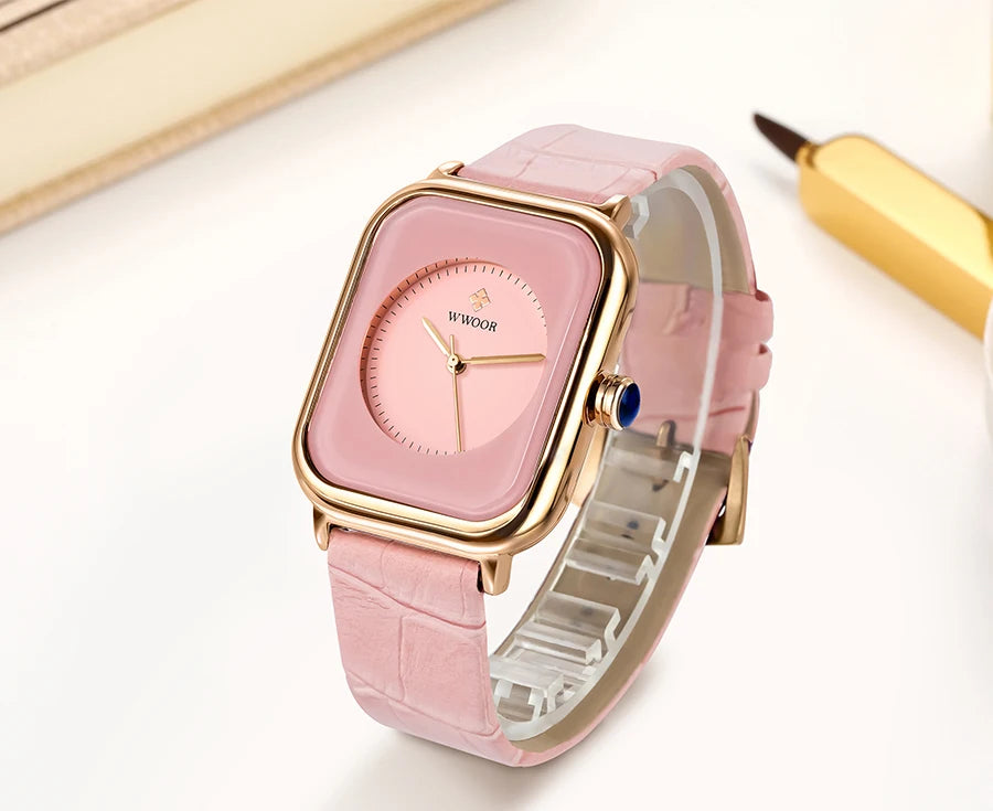 Ladies' square watch with a pink croc-effect leather strap, gold-tone frame, and pink circular dial.