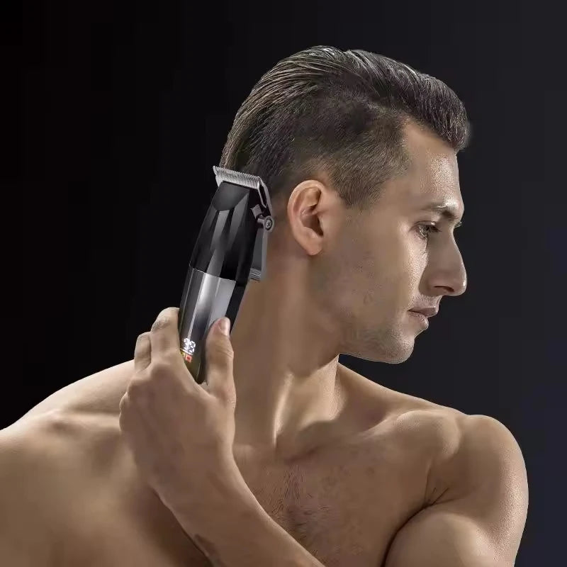 A man using a sleek, black and silver cordless T-blade trimmer to groom his hair against a dark background.