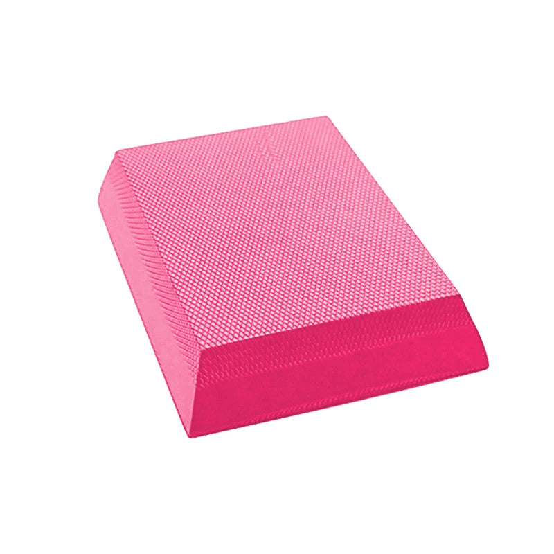 A bright pink, rectangular TPE foam balance pad featuring a non-slip, diamond-patterned textured surface.