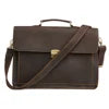 Dark brown genuine leather laptop satchel with a top handle, adjustable shoulder strap, and metal clasp closure.