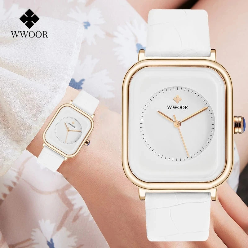 Elegant ladies' watch with a square gold-tone case, white dial and textured white leather strap on a wrist.