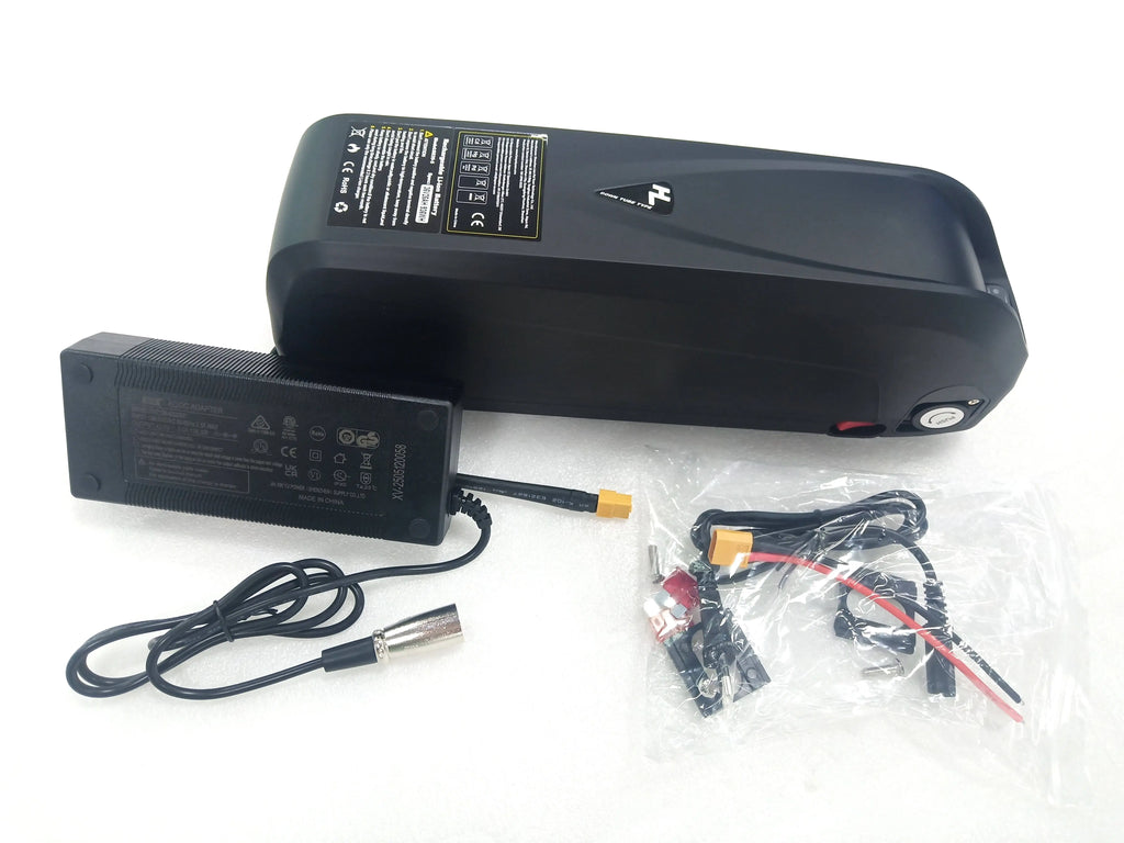 Black e-bike down tube battery with charging adapter and connection hardware set on a white background.