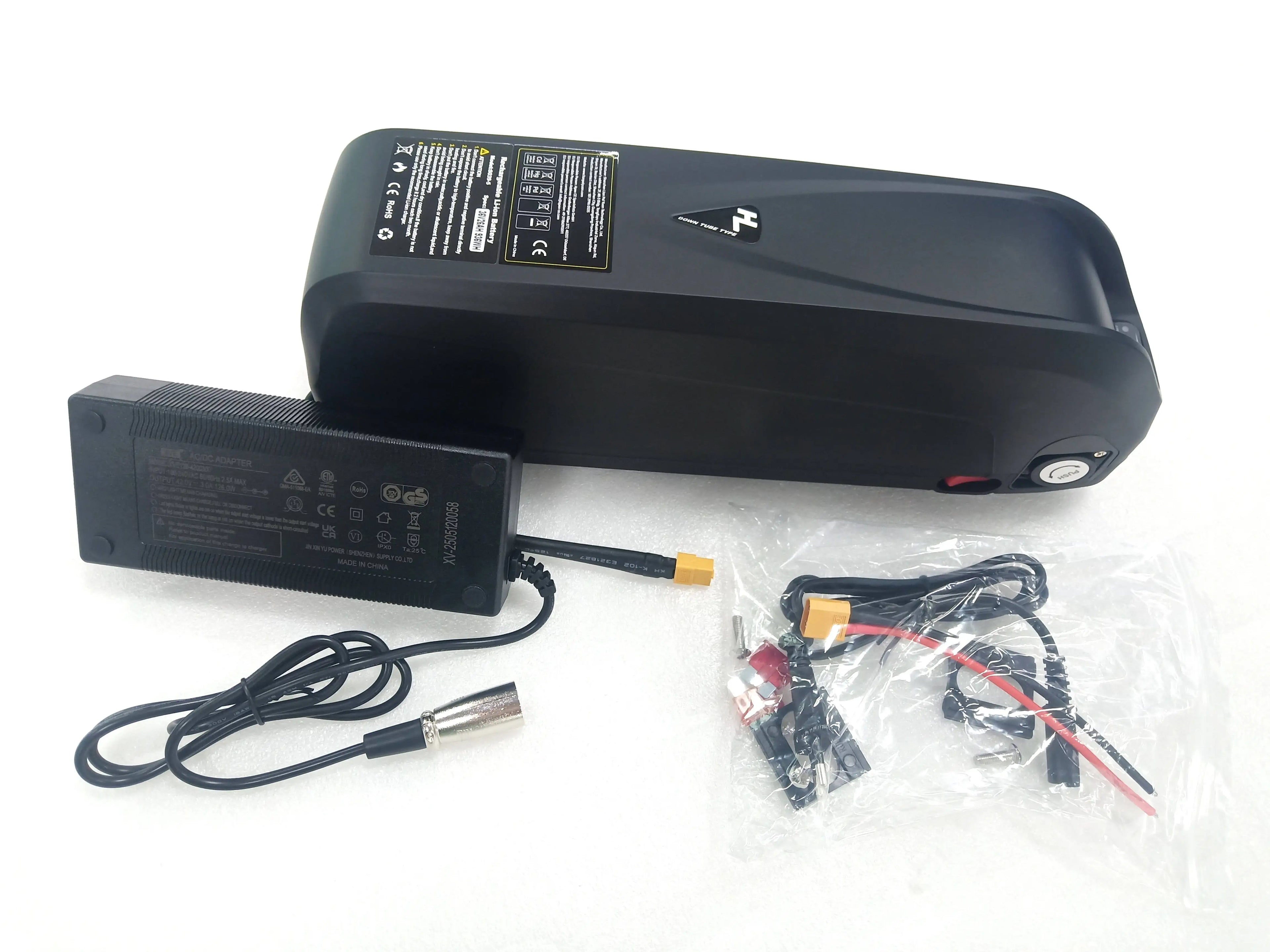 Black e-bike down tube battery with charging adapter and connection hardware set on a white background.