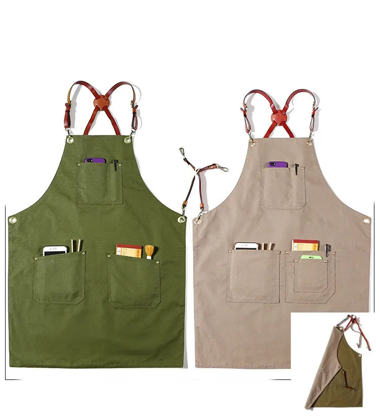 Two durable canvas work aprons in olive green and beige, featuring leather cross-back straps and multiple utility pockets.