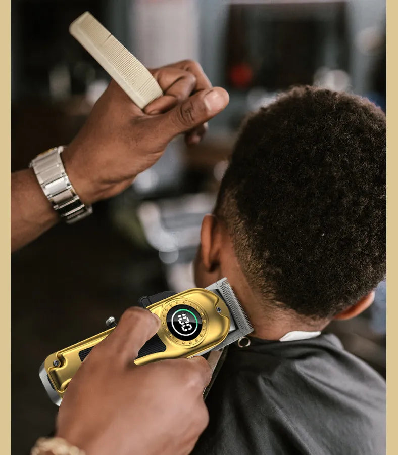 A barber using a gold-finished electric hair clipper with a digital LED battery display on a client's neckline.