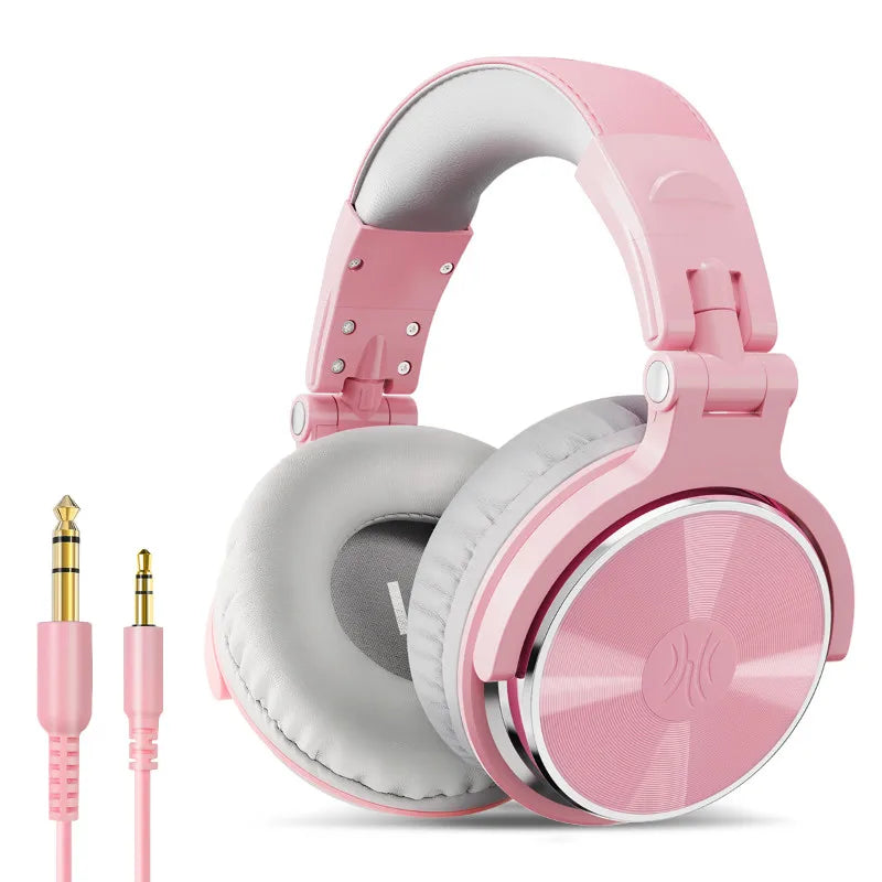 Pastel pink wired over-ear studio headphones with grey cushioned ear pads and a matching 3.5mm and 6.35mm jack cable.