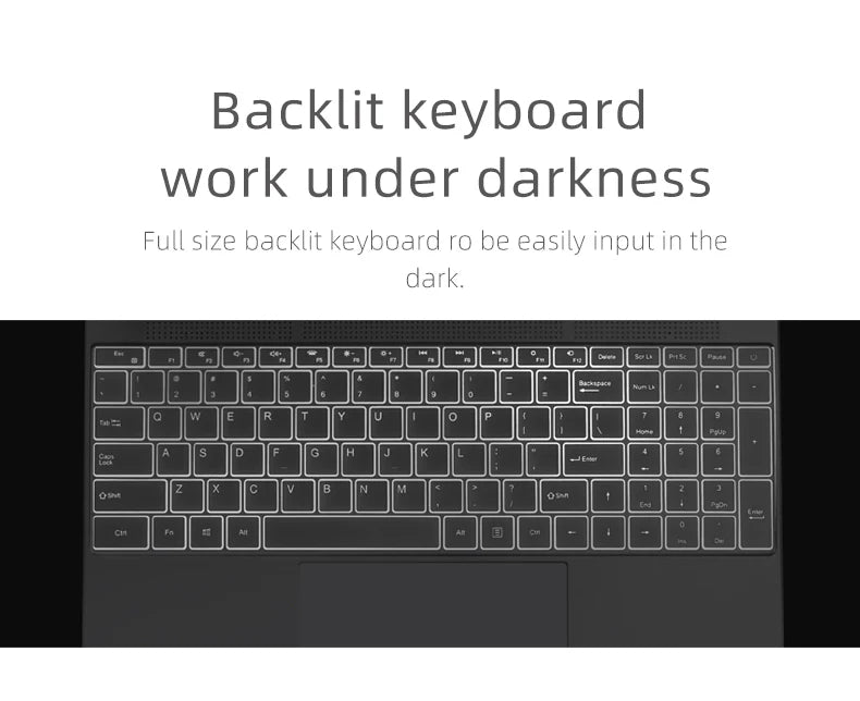 Close-up of a modern dark-grey laptop, featuring a full-size backlit keyboard for easy typing in low-light conditions.