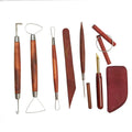 Set of professional clay sculpting tools with dark wood handles and stainless steel metal tips.