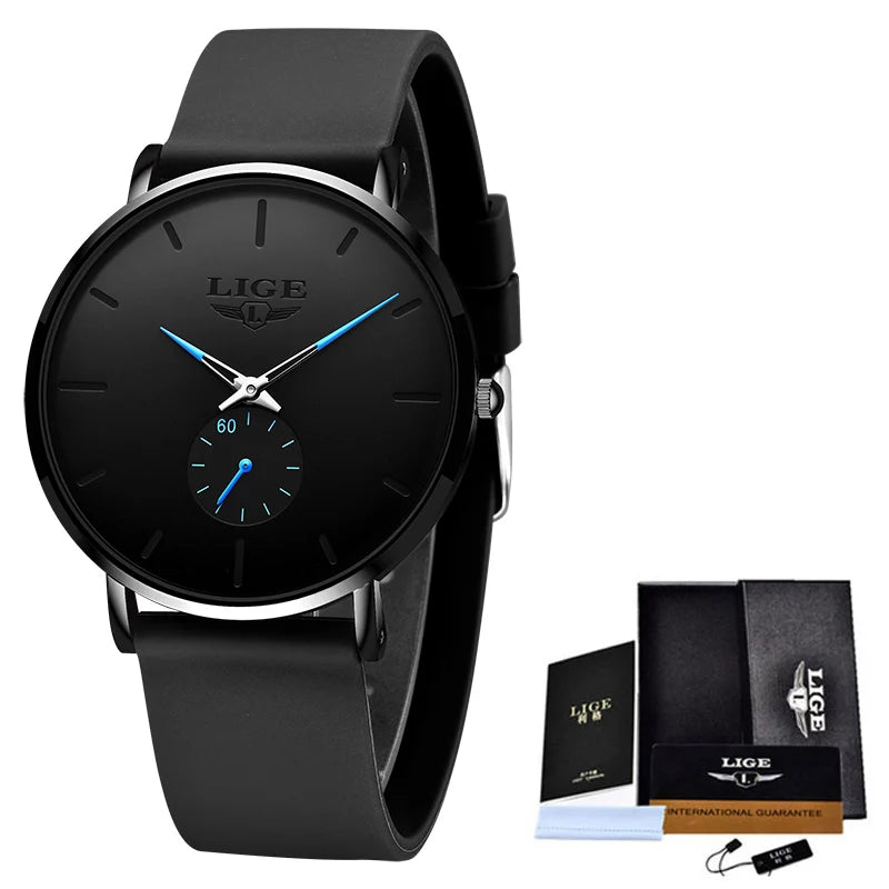Black LIGE ultra-thin quartz watch with round dial, blue hands, subdial, and black silicone strap next to a box.