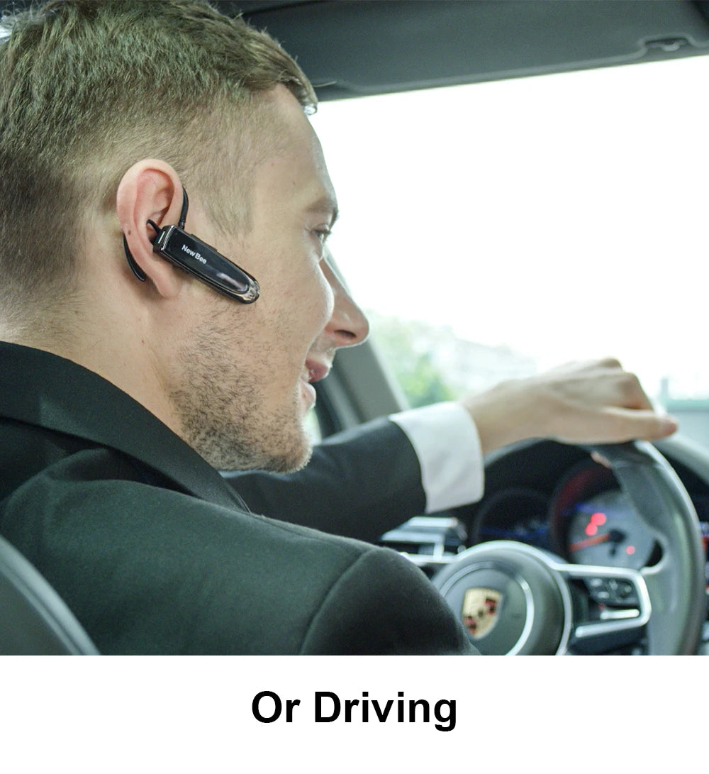 Man wearing a slim, black wireless Bluetooth headset with microphone whilst driving a car.