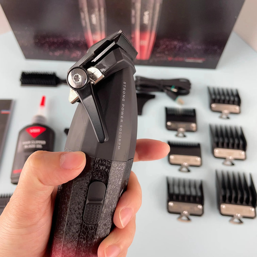 A hand holding a professional, black cordless hair trimmer with blade adjustment lever, plus accessories and guard combs.