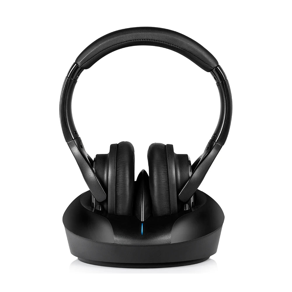 Black wireless TV headphones with cushioned ear cups, sitting on a sleek charging transmitter base.
