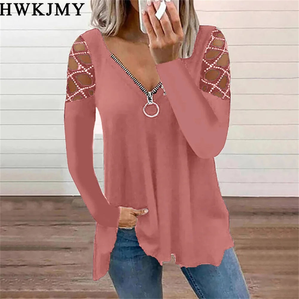 Dusty pink long-sleeve top with v-neck zip detail and decorative lattice-style cut-outs on the shoulders.