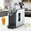 A modern silver and black compact countertop appliance with a clear top loading section on a kitchen marble countertop.