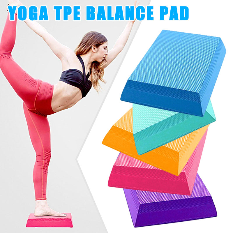 A woman doing yoga on a pink balance pad, with a stacked set of textured TPE foam pads in blue, teal, orange, and pink.