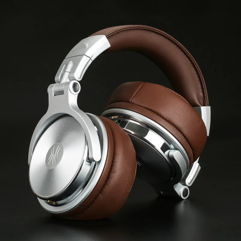 Professional over-ear studio headphones in silver and brown with soft leather-look padding against a black background.