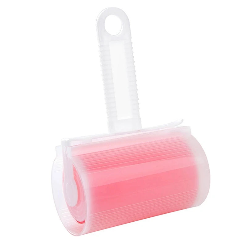 Reusable pink adhesive lint roller with a clear plastic handle and protective cover on a white background.