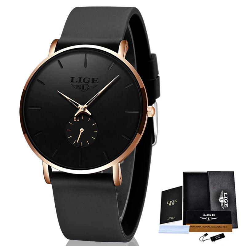 Black men's quartz watch with round rose gold case, black dial, slim hands, and a black silicone strap, with a gift box.