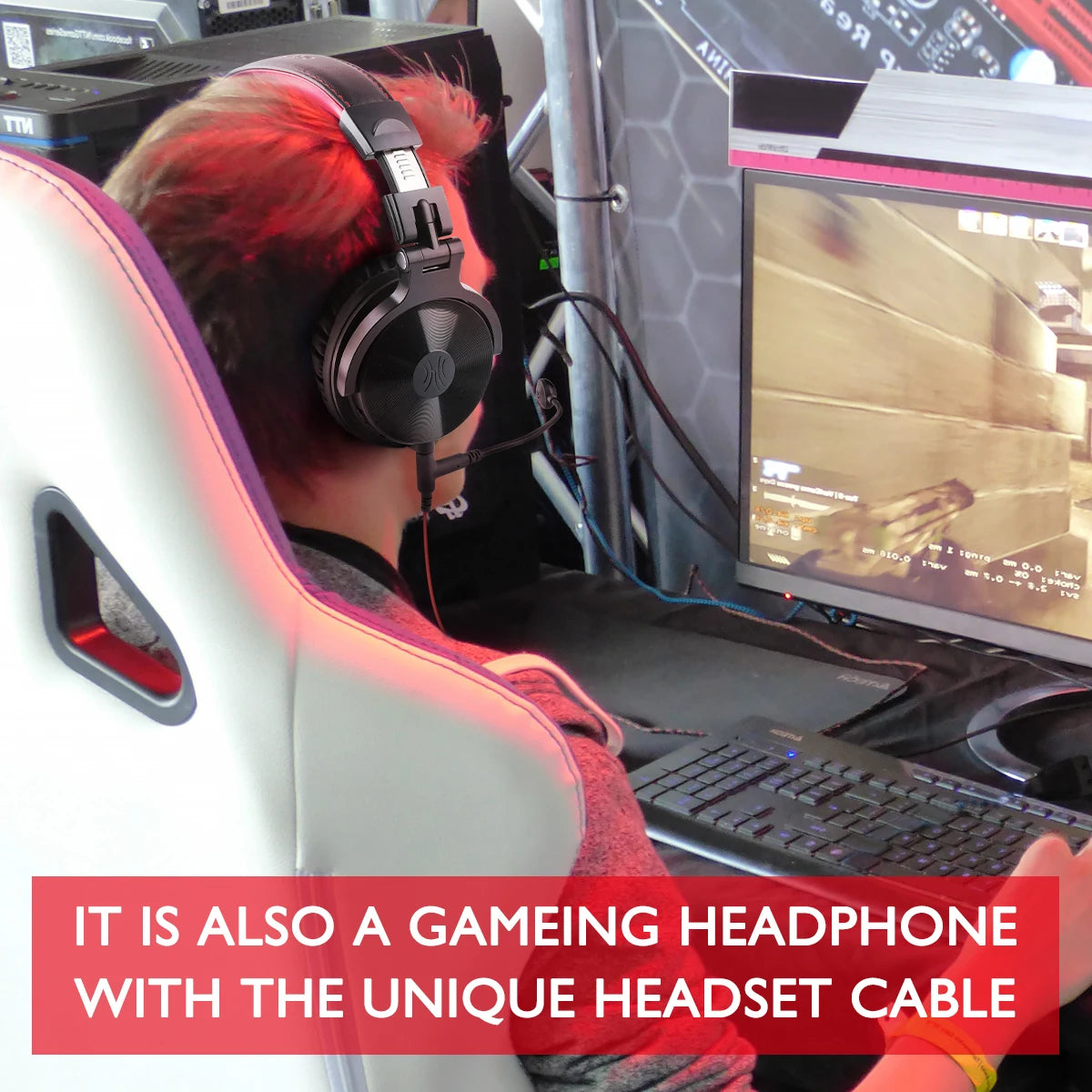 Black wireless over-ear gaming headphones featuring a flexible boom microphone, worn by a person at a PC.