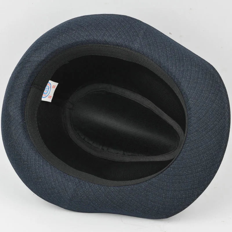 An overhead view of a dark grey, textured fedora hat showing the inner lining and brim structure.
