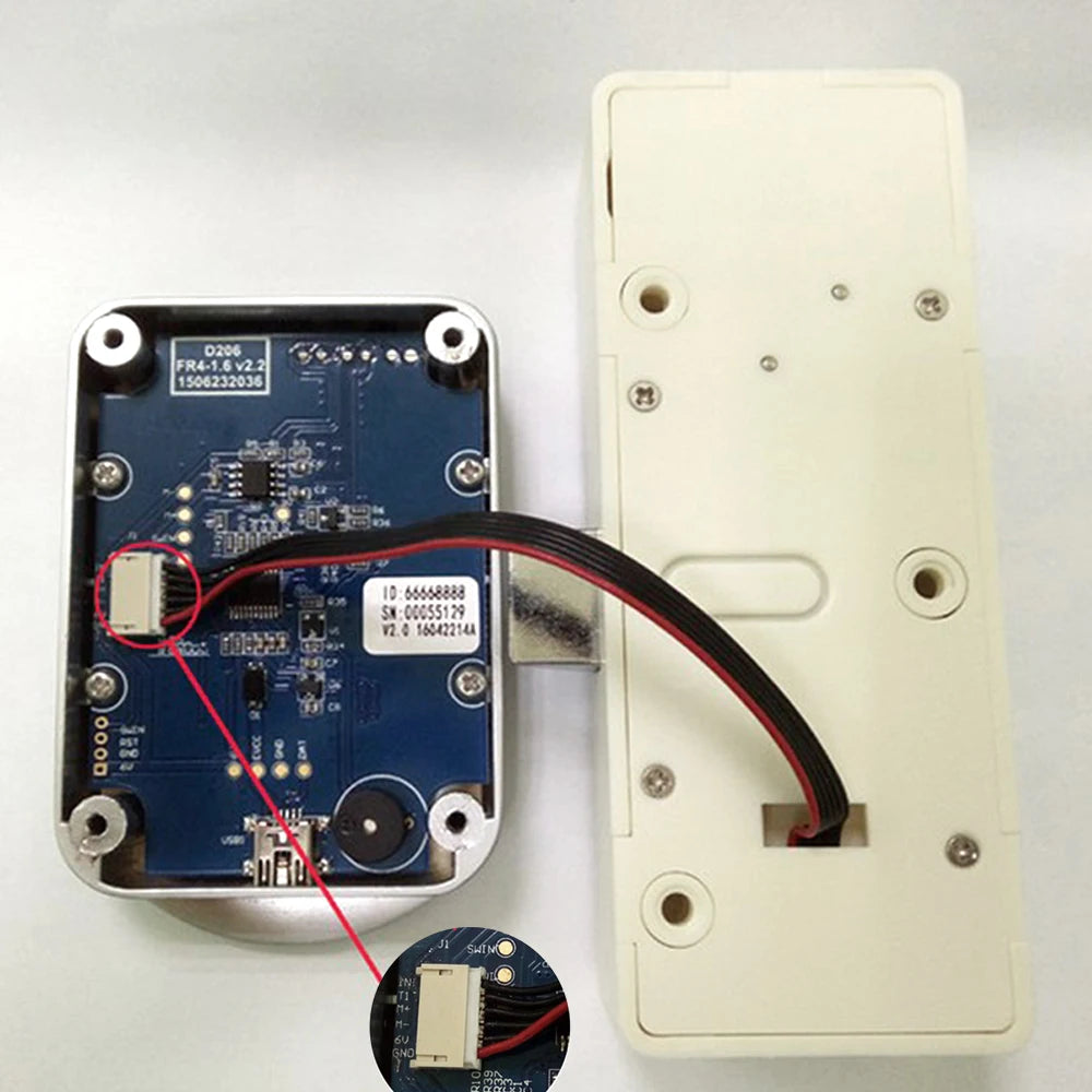 Electronic door lock components: metal internal mechanism with a blue circuit board connected to a white plastic base.