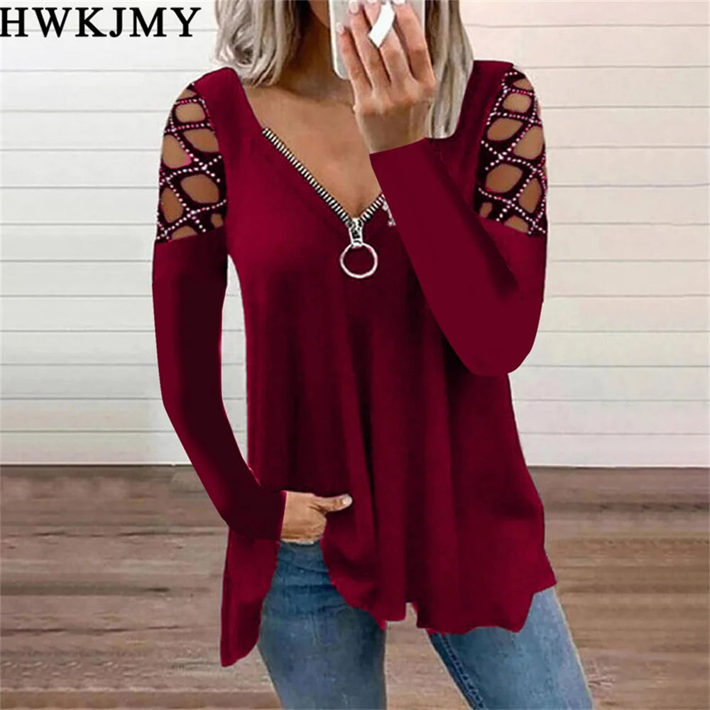 Deep red long-sleeve top with a zip-up V-neck and decorative lattice cut-out shoulders.
