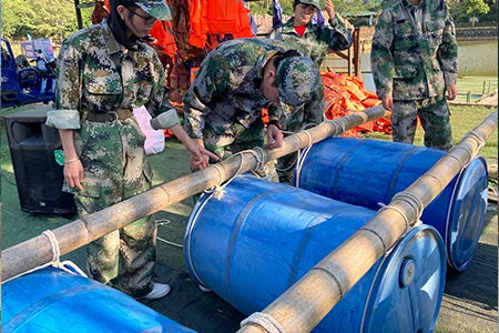 Please provide the image of the backpack. The image provided shows people building a raft with barrels.