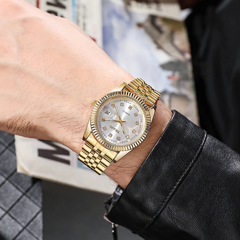 Men's gold-tone quartz watch with a fluted bezel, link bracelet, and crystal-studded indices on a silver dial.