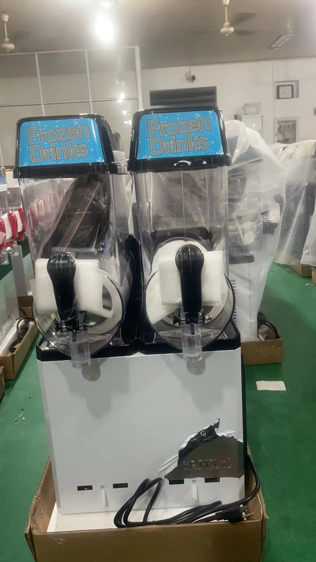 Two-bowl commercial slush machine with clear tanks and 'Frozen Drinks' branding.