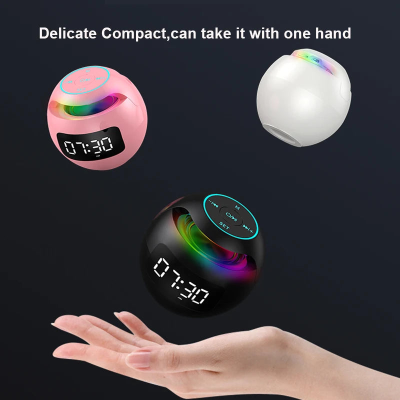 Three compact, spherical Bluetooth speakers in pink, white, and black, each featuring an LED clock and ambient lighting.