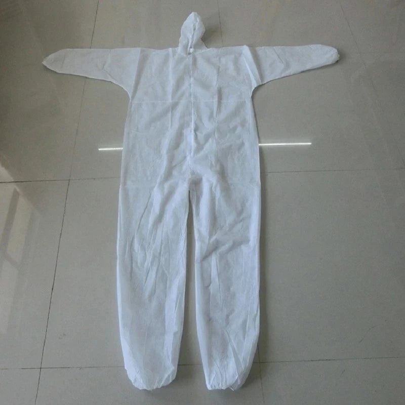 White disposable protective coverall made of non-woven material with an attached hood and elastic cuffs.