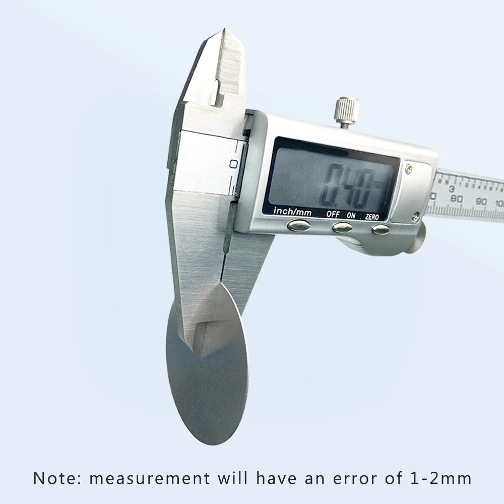 Silver digital vernier caliper measuring a circular metal disc against a light blue background.
