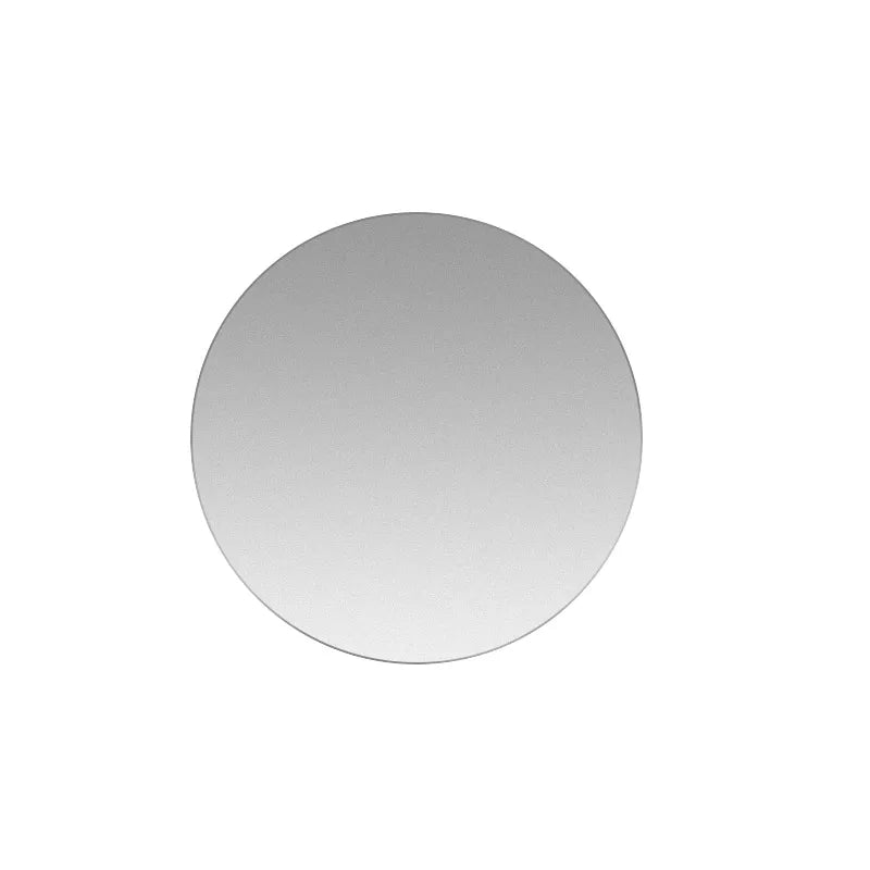 Minimalist circular wall mirror with a sleek, frameless design and a smooth, reflective silver finish.
