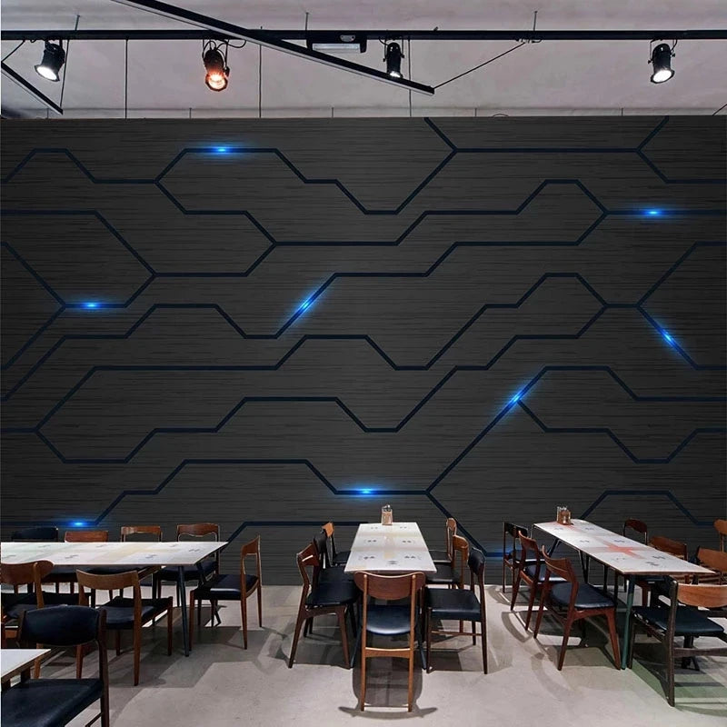 Modern dark grey 3D feature wallpaper with a geometric circuit-board design and reflective blue light accents.