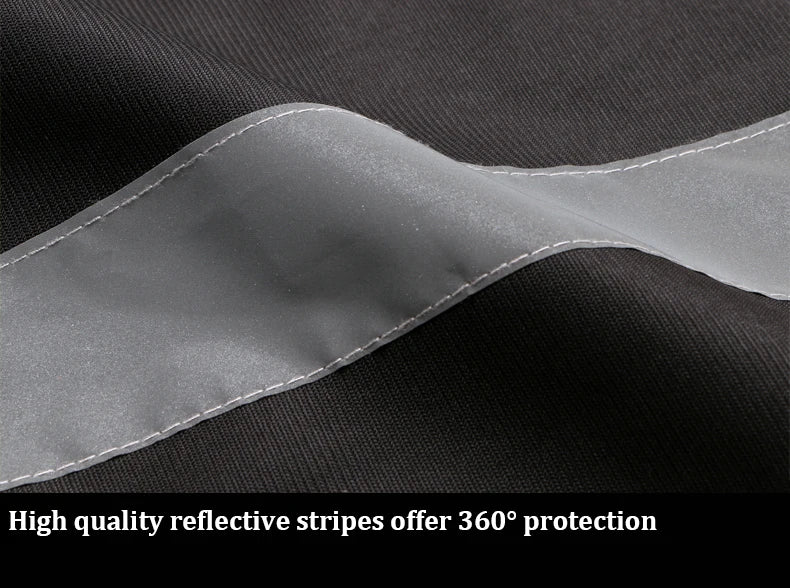 Close-up of black high-visibility work vest fabric featuring high-quality reflective safety stripes.