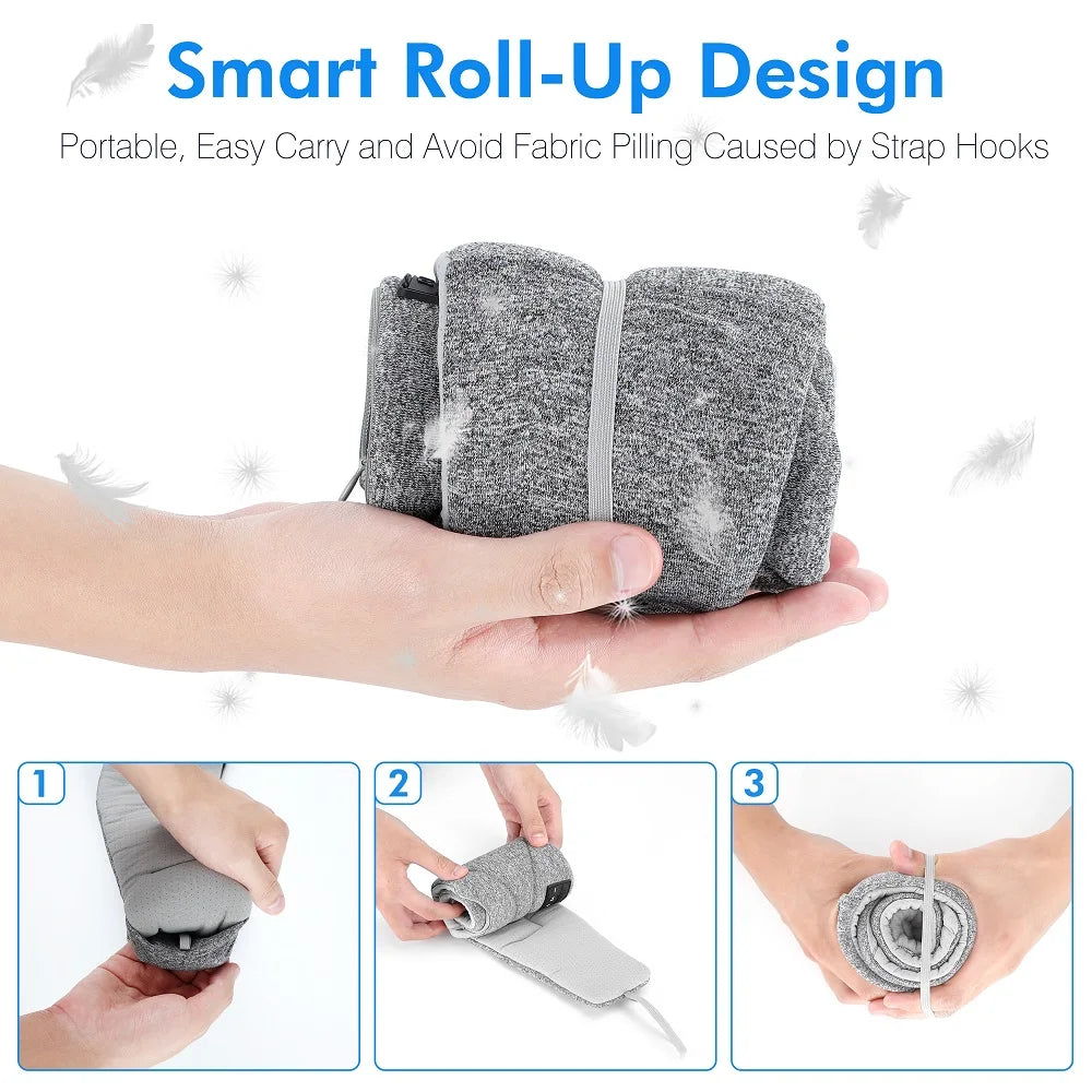 Grey, fabric-covered Bluetooth sleep eye mask shown being rolled up into a compact, portable size by hand.