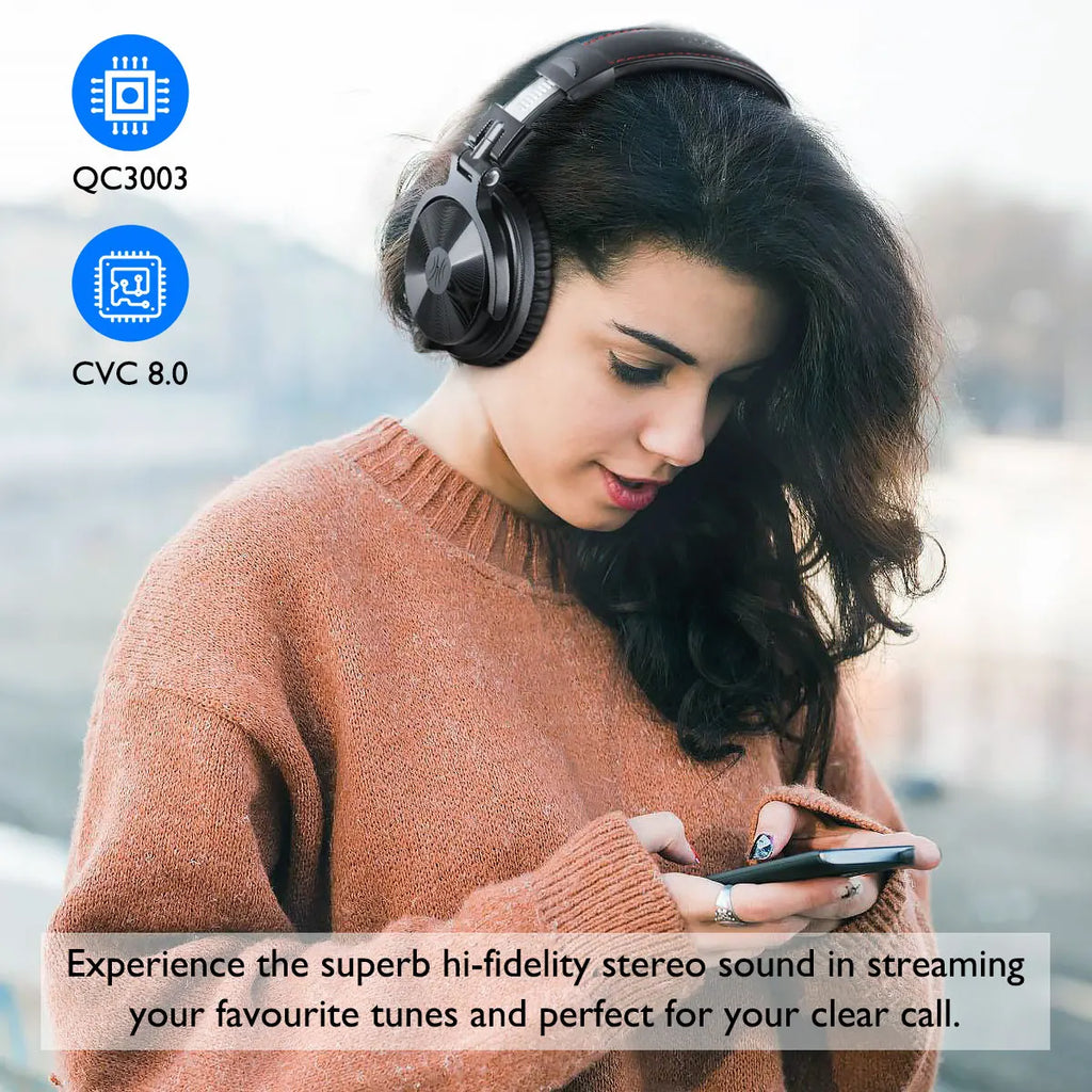 A person wearing sleek, black over-ear wireless headphones with a built-in microphone while using a smartphone.