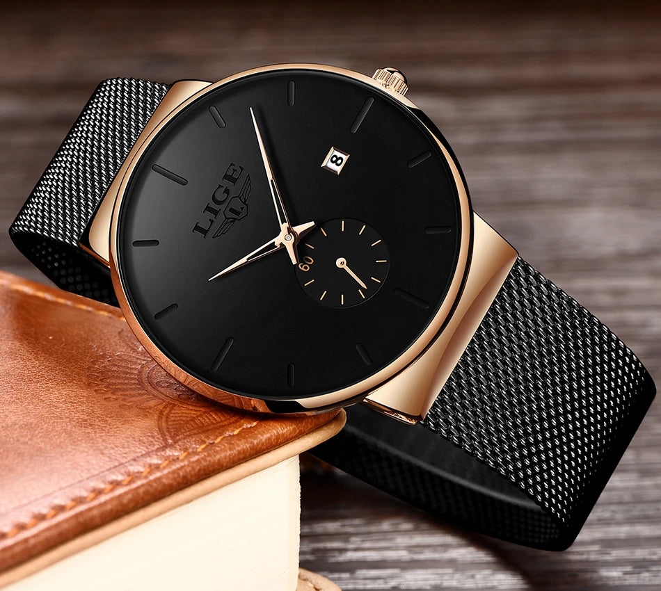 Elegant women's watch with a black dial, rose gold case, and a slim black stainless steel mesh strap.