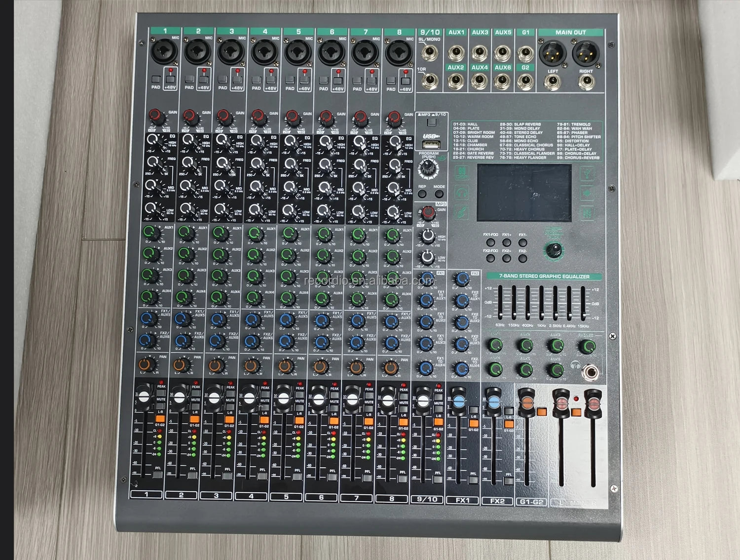 Grey 8-channel audio mixer with multiple input ports, rotary dials, faders, a digital screen, and graphic equaliser.