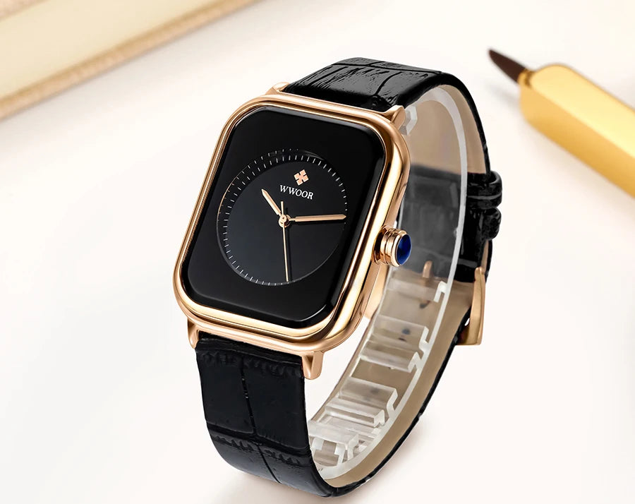 Ladies’ square watch with a gold-tone case, black dial, and black croc-effect leather strap.