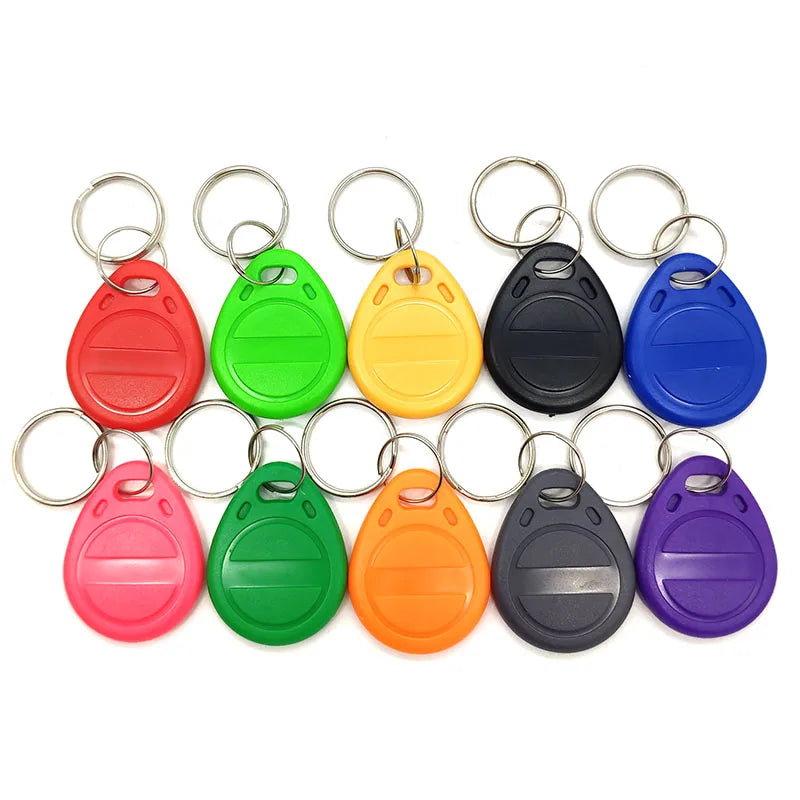 Ten colorful plastic RFID key fob tags with metal rings arranged in two rows against a white background.
