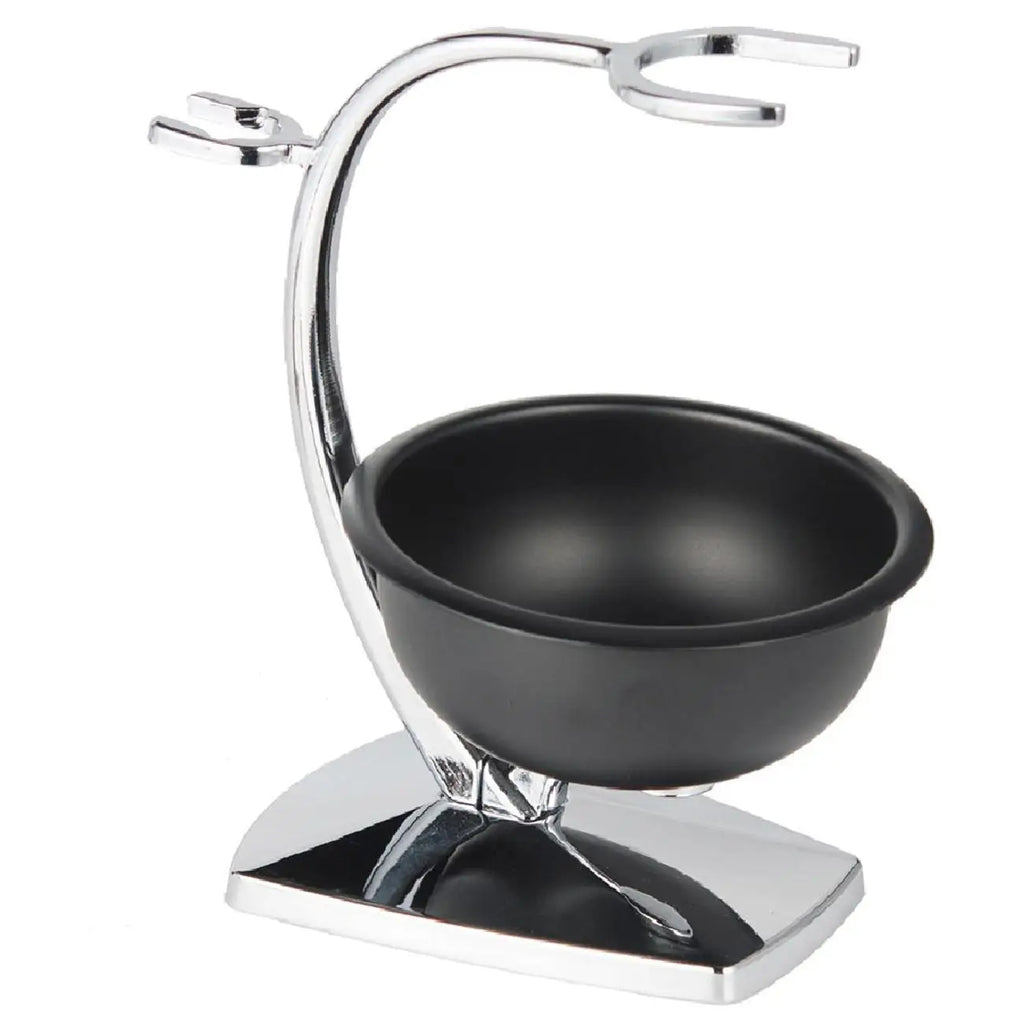 A chrome shaving stand with a curved holder for a razor and brush, featuring a matte black shaving bowl on a base.